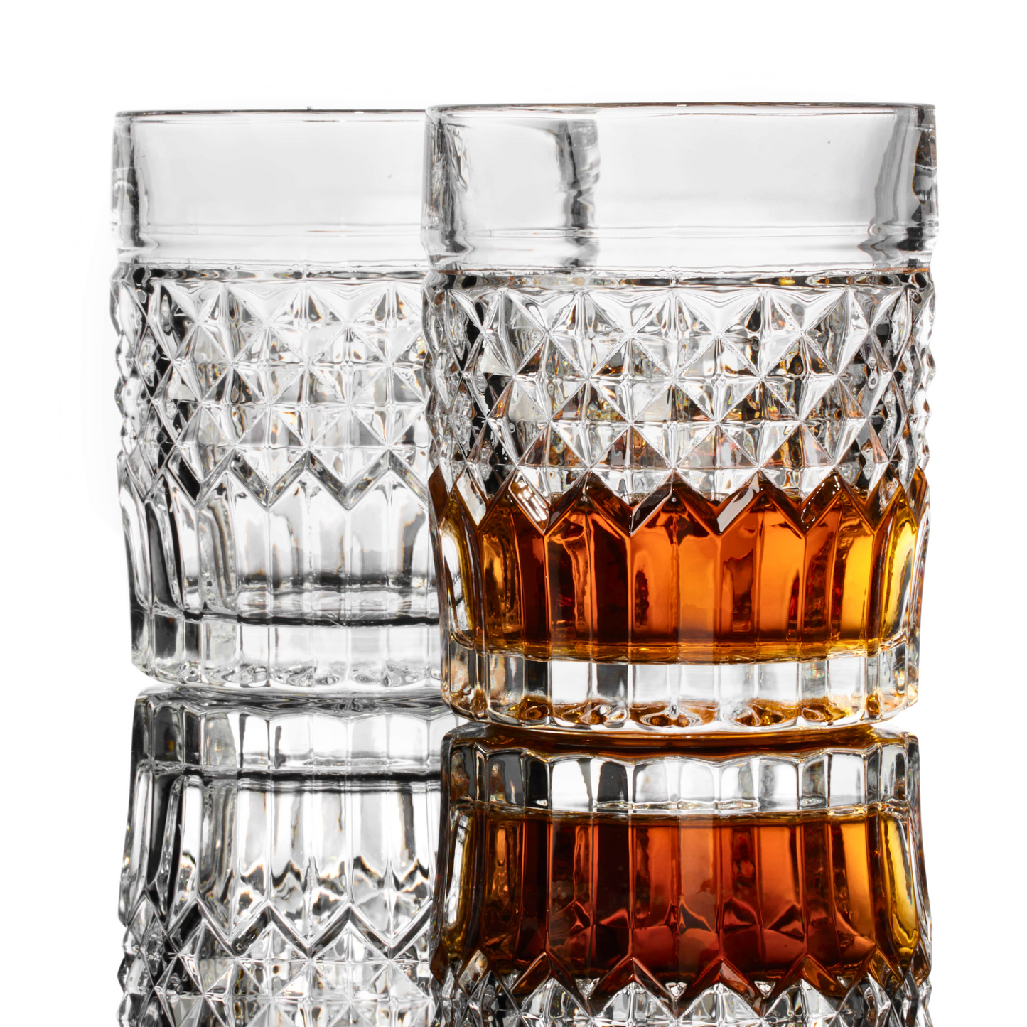Prestige whiskey glass privilege collection — high-end gift set for dad who drinks scotch Two crystal glasses, one filled with amber liquid, on a white background