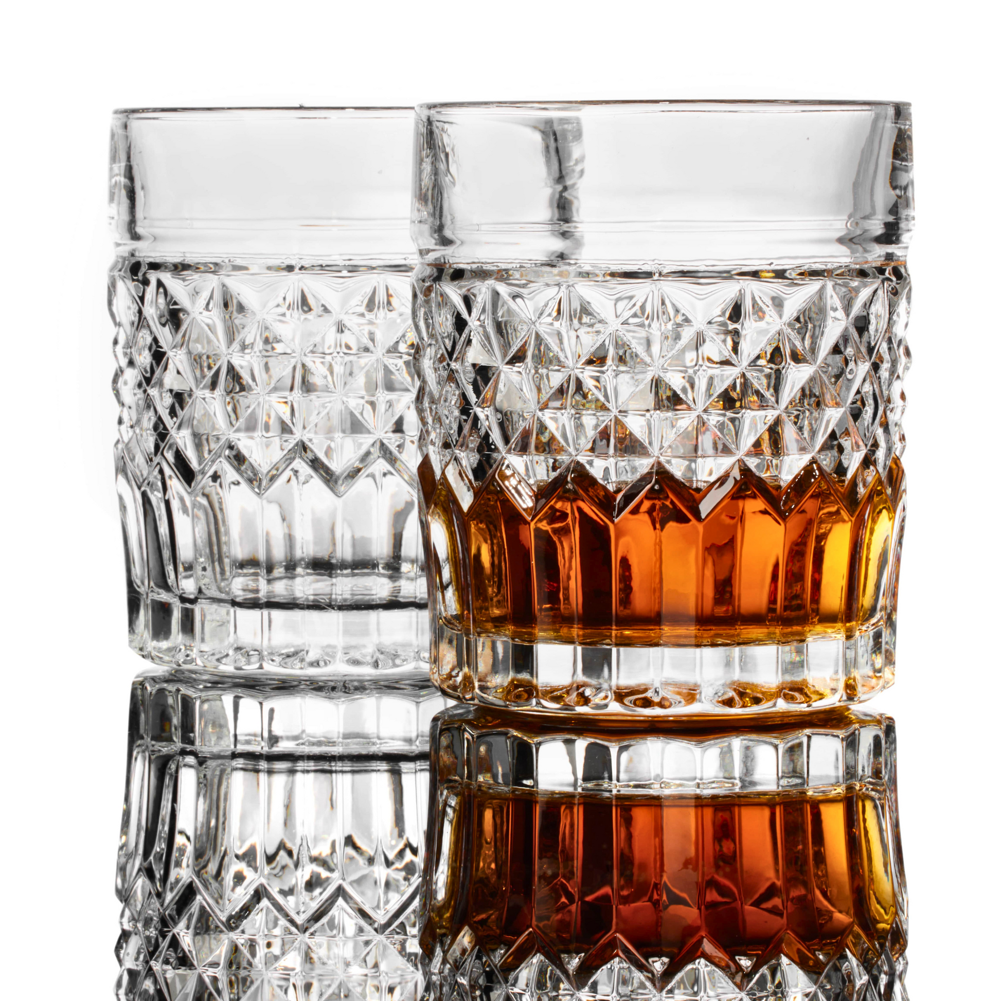 Prestige whiskey glass privilege collection — high-end gift set for dad who drinks scotch Two crystal glasses, one filled with amber liquid, on a white background