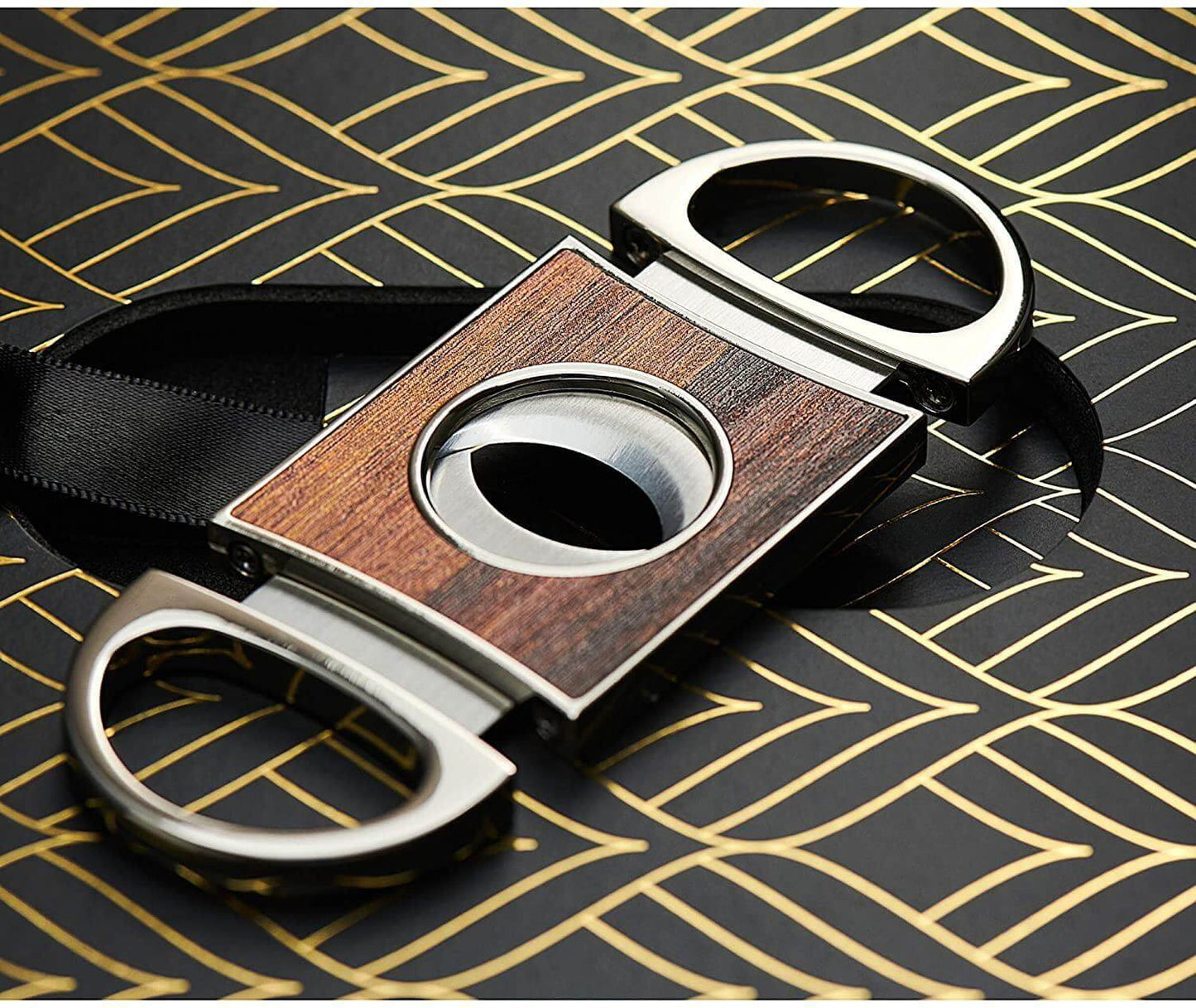 Cigar cutter with wooden finish and metal handles on a patterned surface luxury cigar and whiskey gift for dad