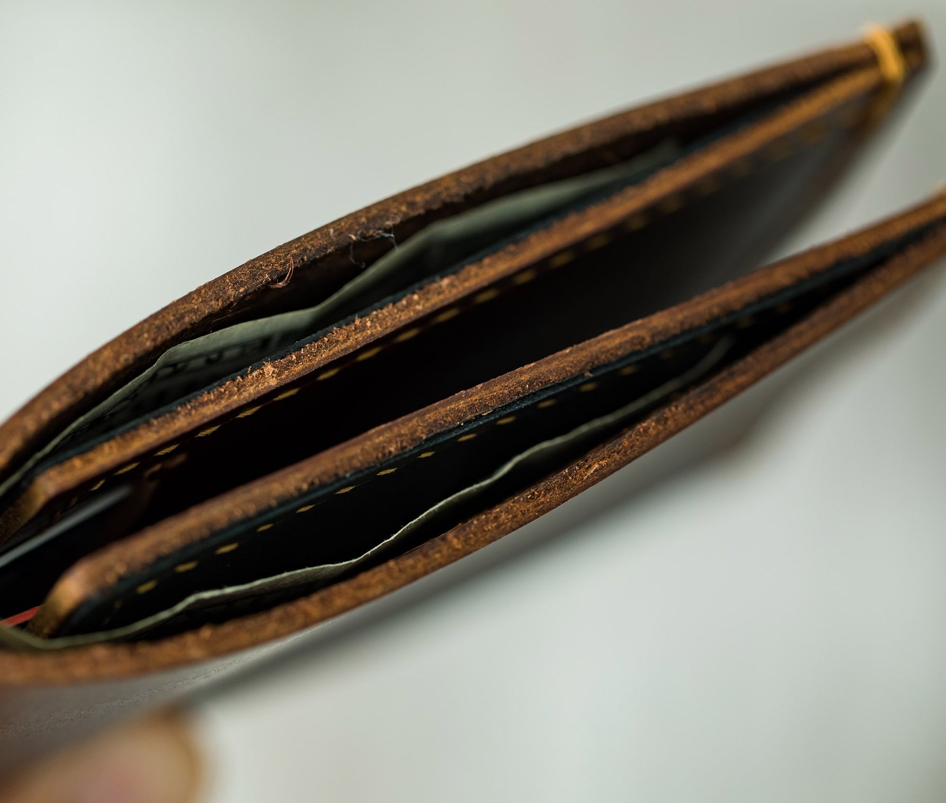 Close-up of a brown leather wallet with cards on a light gray background personalized gift for dad