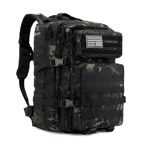 Tactical backpack in black multicam camo pattern with flag patch, front angle view