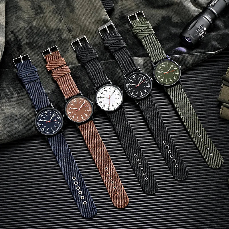 Military field watch lineup showing all five strap colors: blue, coffee, white-black, black, and green